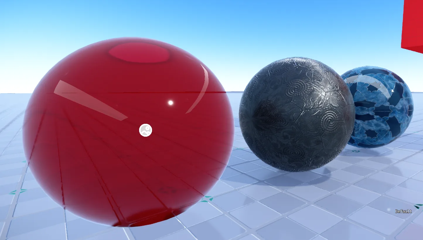 Three material test spheres: glossy translucent red, embossed dark metal and blue marble