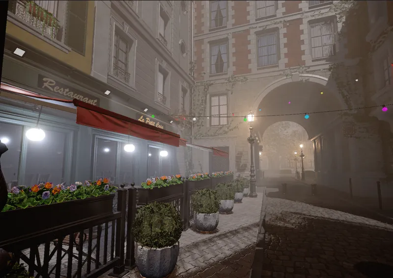 A foggy cobbled street with a restaurant terrace, flower boxes and strings of coloured lights